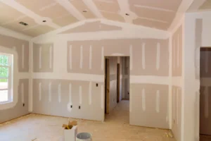 Drywall ceiling beside a T-bar ceiling system in an Edmonton interior project